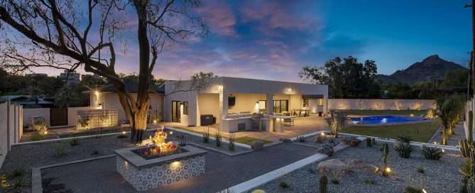 backyard with plants professionally lit up with Lighting - McCreery - Water-Efficient Landscaping for Water Conservation