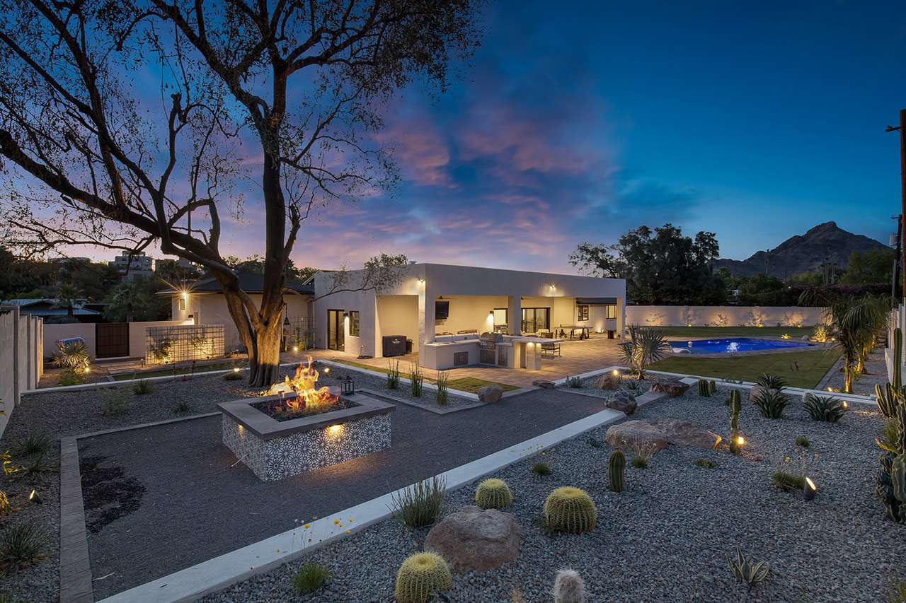 backyard with plants professionally lit up with Lighting - McCreery - Water-Efficient Landscaping for Water Conservation